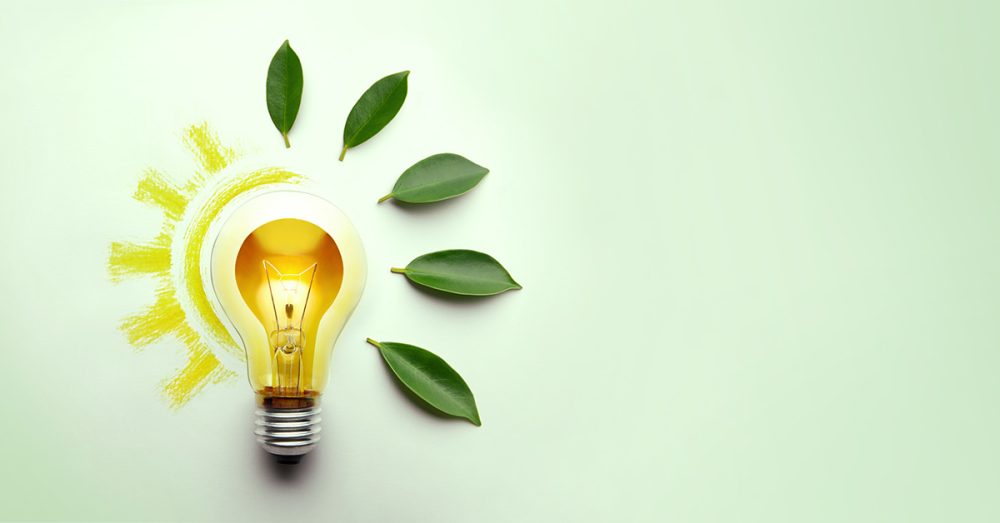 Green Energy Concepts. Wireless Light Bulb surrounded by Green Leaf form as Sign of Lights On. Carbon Neutral and Emission ,ESG for Clean Energy. Sustainable Resources, Renewable and Environmental Care